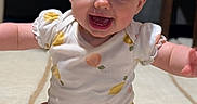 Layla is registered to the contest to win money with this photo: baby, infant, smiling, happy, onesie, fruit_pattern, sitting, carpet, child, cute, indoors, portrait, cheerful, young, person, skin, face, head, arms, legs