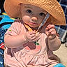Layla is registered to the contest to win money with this photo: baby, child, infant, hat, sunhat, pink_dress, strawberry_print, blanket, blue_blanket, soft_lighting, indoor, cute, portrait, close_up, hand, face, eyes, expression, sitting, cozy