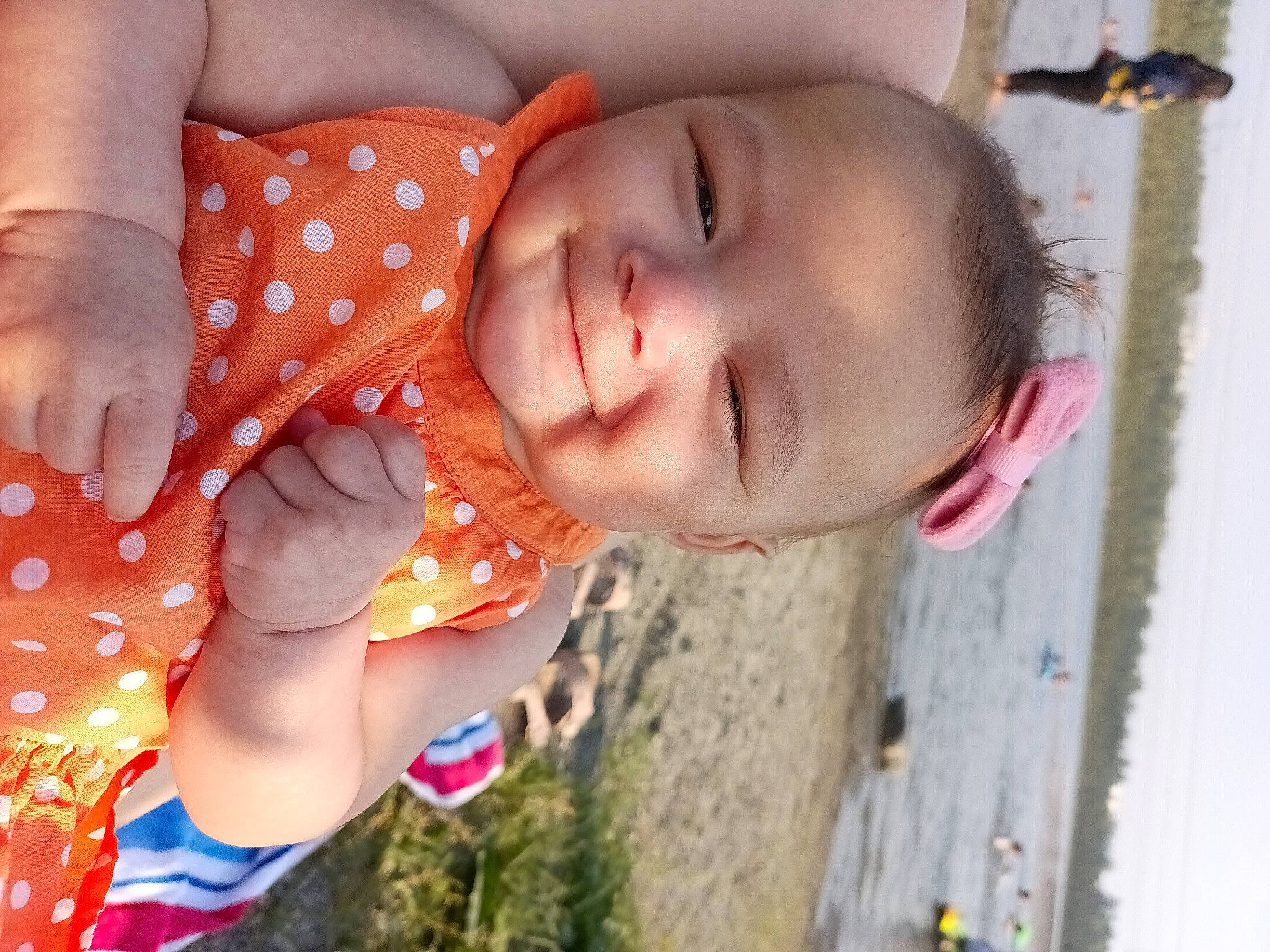 Alexandria is registered to the contest to win money with this photo: baby, baby_toddler_clothing, cheek, chest, child, fun, happy, human_leg, leisure, mouth, nail, nose, pattern, people_in_nature, person, play, skin, smile, summer, toddler