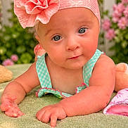 Lilith is registered to the contest to win money with this photo: baby, infant, headband, flower, blanket, greenery, outdoor, garden, picket_fence, curious, child, cute, portrait, pink, blue_eyes, soft_texture, summer, toddler, smiling, natural_light