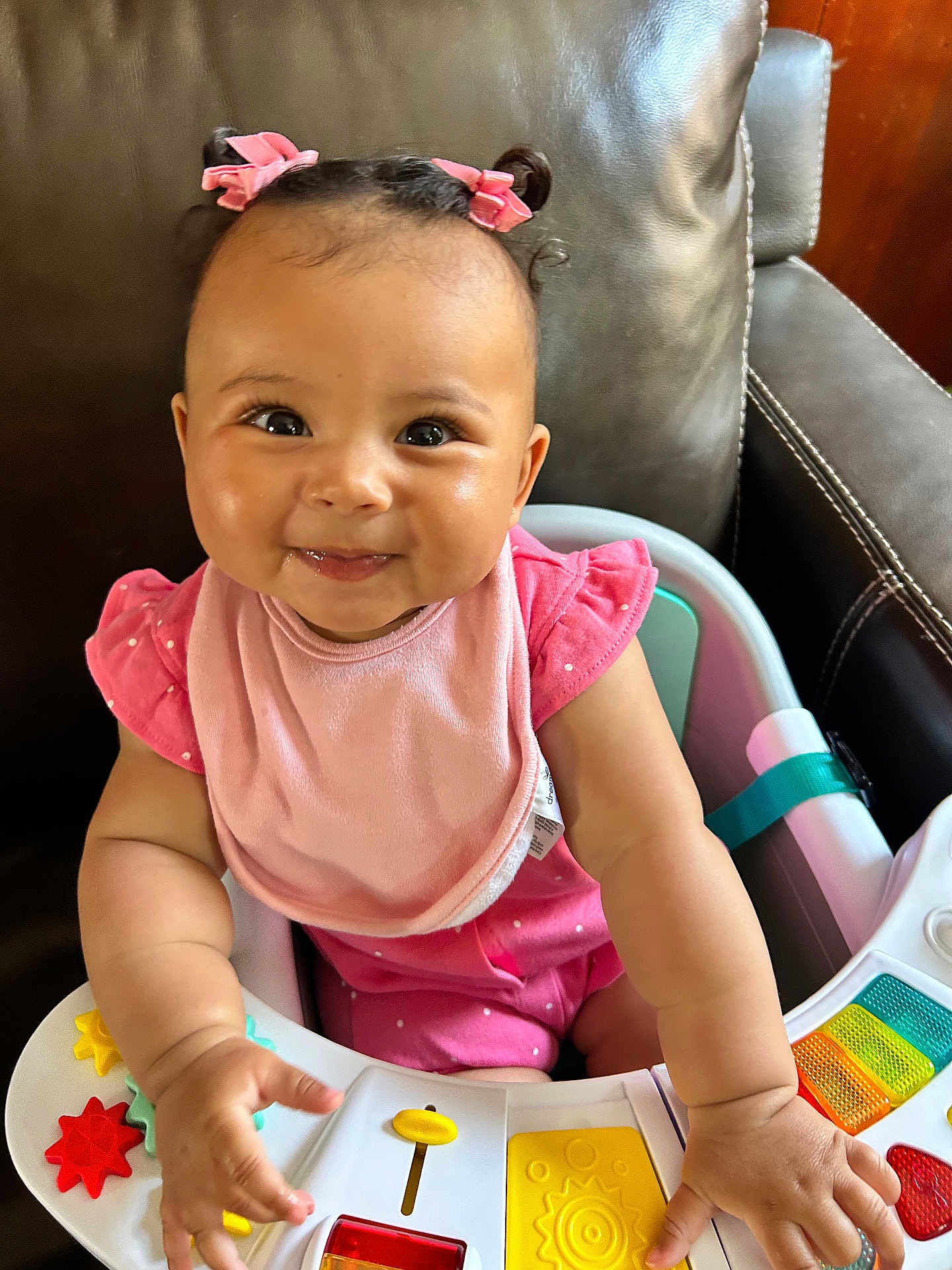 Haven joined the competition — help win amazing prizes! baby, infant, child, pink_bib, pink_clothing, baby_walker, toys, colorful, happy, smiling, cute, indoor, seat, hands, face, eyebrows, hair_bows, cheeks, playful, curious