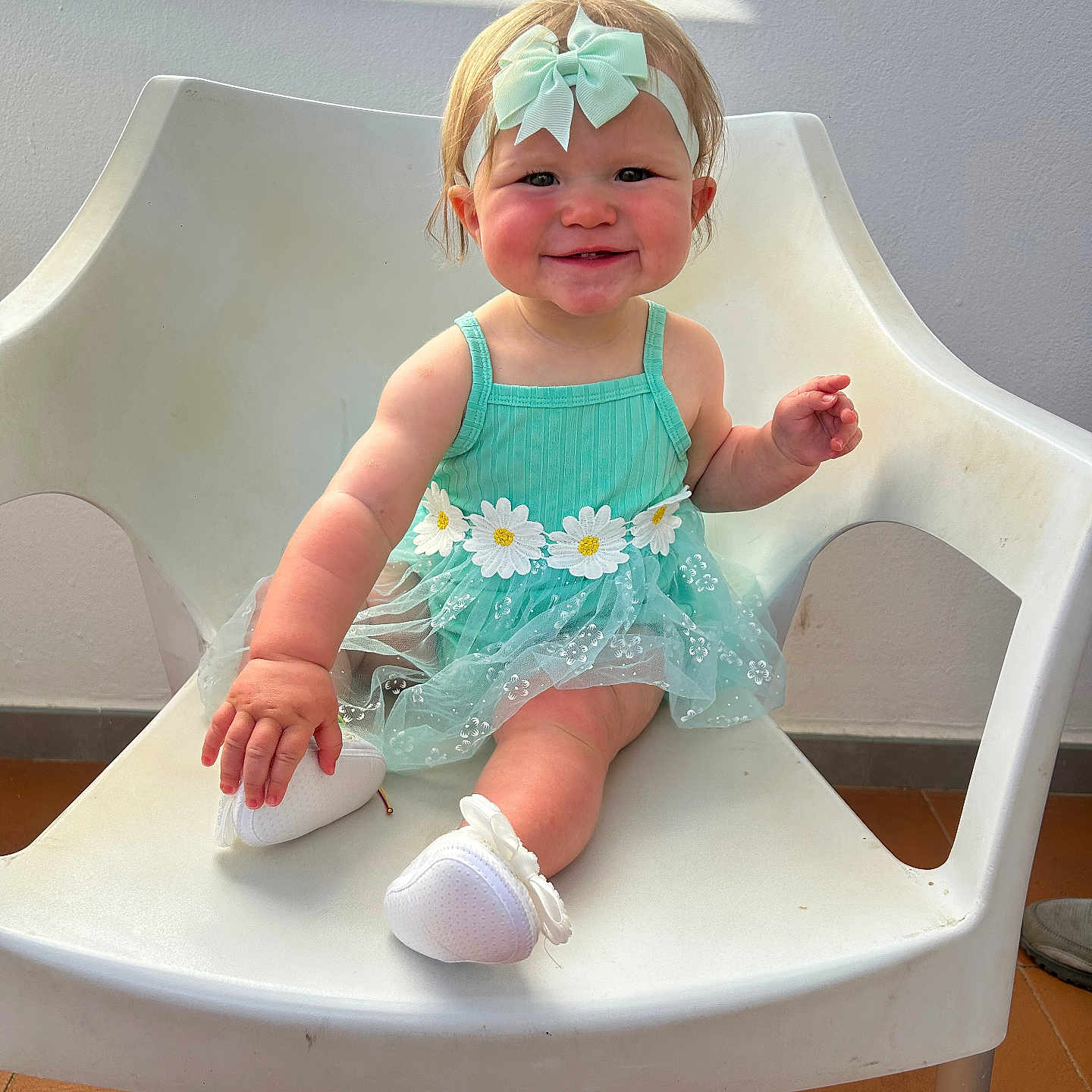 Bonnie-Mai is registered to the contest to win money with this photo: baby, chair, child, cute, daisy, dress, flower, footwear, happy, headband, indoor, light, person, portrait, shadow, shoe, sitting, skin, smiling, white_chair