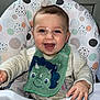 Morgan is registered to the contest to win money with this photo: baby, bib, bodypart, chair, clothing, coat, cushion, cutlery, face, furniture, happy, head, homedecor, jacket, mouth, person, photography, portrait, spoon, teeth