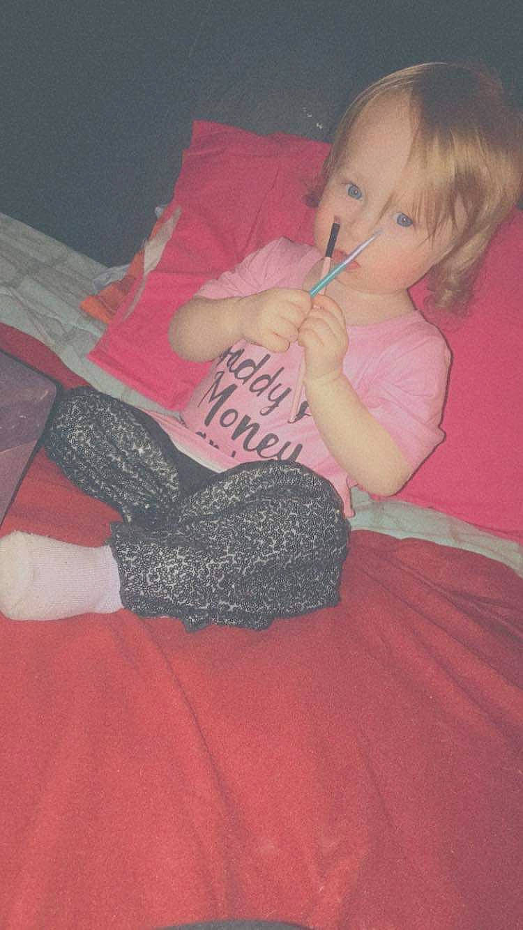 Abigail is registered to the contest to win money with this photo: baby, baby_toddler_clothing, child, comfort, eye, finger, flooring, foot, hair, head, human_leg, knee, lap, magenta, mouth, pattern, person, pink, shoulder, thigh