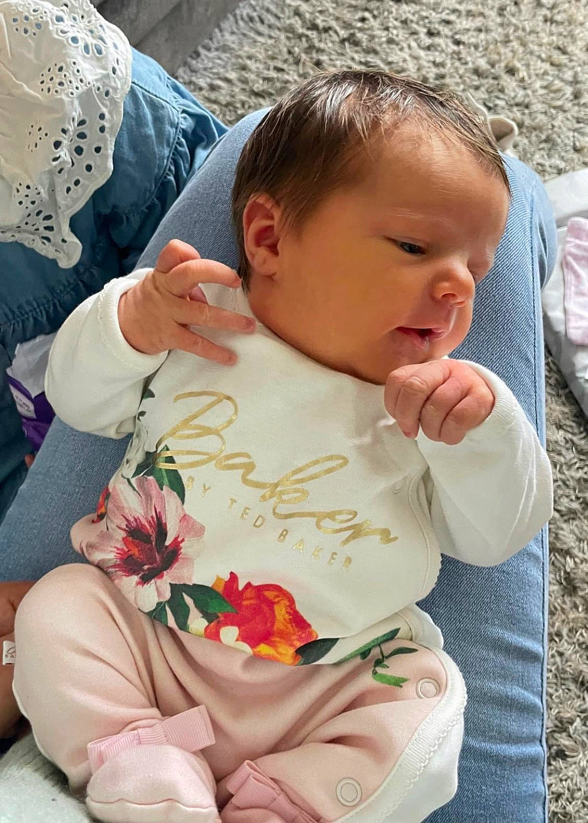 Dolly joined the competition — help win amazing prizes! baby, baby_products, baby_toddler_clothing, cheek, child, comfort, dress, finger, fun, grass, hand, happy, lap, nose, pattern, person, sitting, skin, spring, toddler