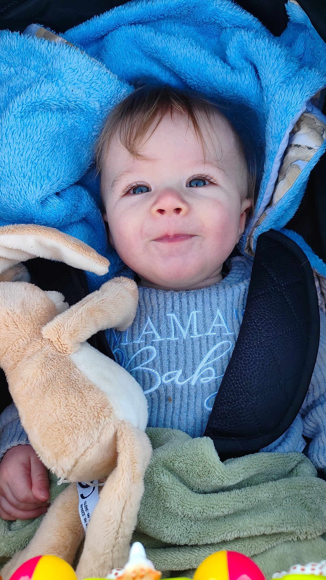 Evan participe au concours pour gagner de l'argent avec cette photo : baby, infant, child, portrait, smile, blue_blanket, plush_toy, stroller, car_seat, blue_eyes, eyelashes, sweater, closeup, cozy, blanket, soft_toy, hand, toy, fabric, cute