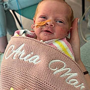 Aria joined the competition — help win amazing prizes! newborn, baby, blanket, pacifier, hospital, nasal_tube, person, hand, chair, clothing, seated, indoor, portrait, pink, knit, support, comfort, baby_care, infant, cute