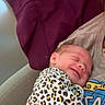 Aria joined the competition — help win amazing prizes! baby, newborn, smile, sleeping, leopard_print, onesie, infant, person, human, resting, couch, blanket, purple, clothing, cute, peaceful, indoor, portrait, parent, comfort