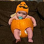 Kayden joined the competition — help win amazing prizes! baby, child, couch, cozy, cute, diaper, expression, face, funny, furniture, hat, holiday, homedecor, indoor, legs, orange, pacifier, pumpkin, sitting, toddler
