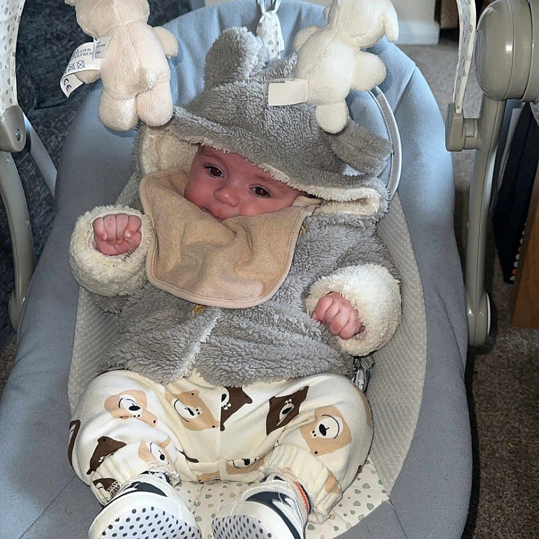 Kayden joined the competition — help win amazing prizes! adorable, baby, baby_bib, baby_clothing, baby_face, baby_rocker, carpet, child, comfortable, cozy, cute, hooded_jacket, indoor, infant, patterned_pants, plush_toys, seated, small_hands, sneakers, soft_toys