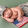baby, sleeping, camouflage, hat, pants, flag, american_flag, hand, peaceful, soft_surface, infant, cute, patriotic, resting, child, skin, portrait, peace, newborn, lying_down