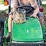 man, tattoo, tractor, green, bobcat, animal, wildlife, outdoor, grass, dirt, vehicle, wheel, steering_wheel, boots, sleeveless_shirt, nature, pet, farm, sunlight, relaxed