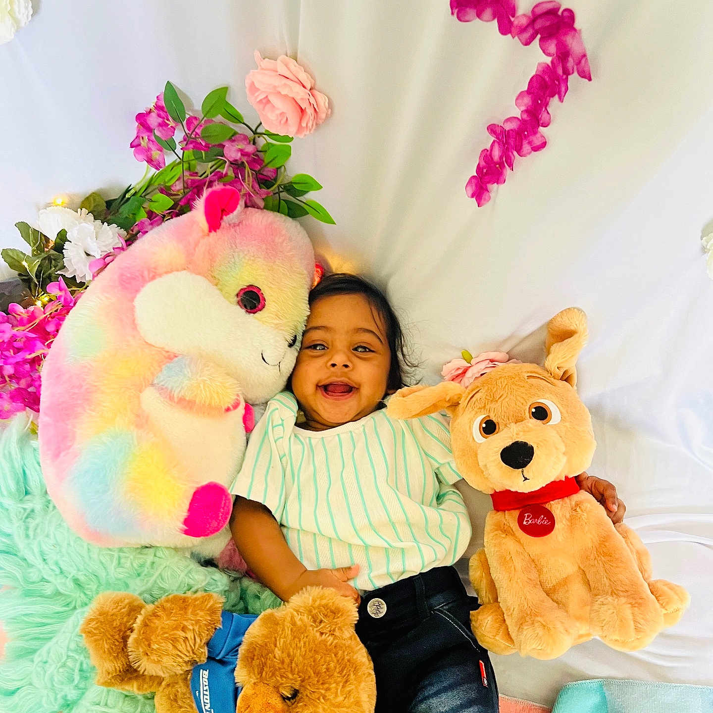 Hethav joined the competition — help win amazing prizes! baby, child, smiling, stuffed_animal, plush_toy, flower, blanket, soft_toy, cuddly, happy, cute, indoor, portrait, lying_down, colorful, toy_dog, toy_bear, toy_unicorn, casual_clothing, playful