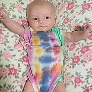 Ivabelle joined the competition — help win amazing prizes! baby, infant, onesie, tie_dye, blanket, floral_pattern, pink, arms_up, lying_down, cute, soft_texture, happy, child, indoors, comfort, newborn, person, skin, smile, cozy