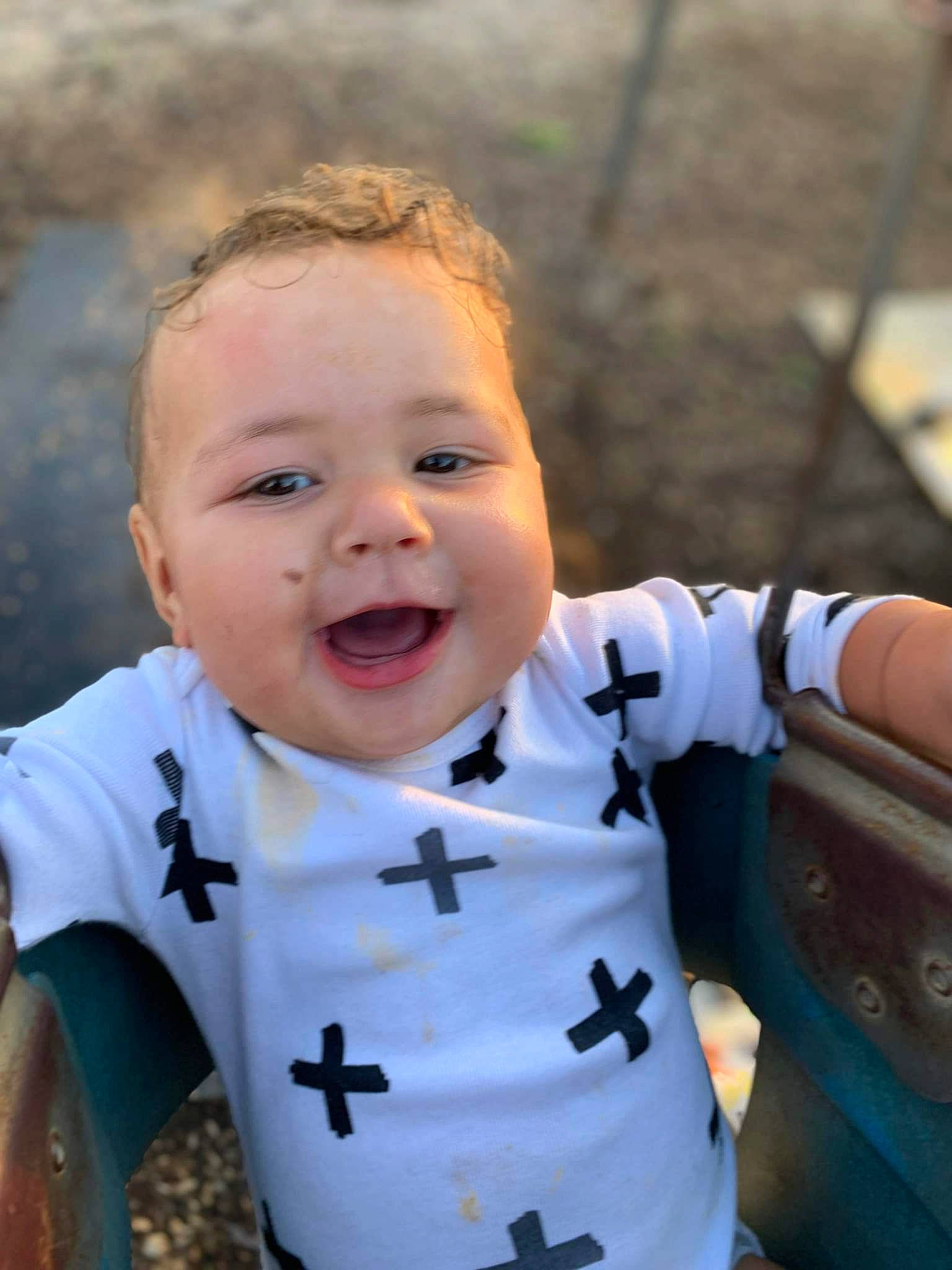 Peyton is registered to the contest to win money with this photo: arm, baby_toddler_clothing, cheek, eye, face, finger, hair, hand, happy, head, human_body, iris, lip, neck, nose, outerwear, person, skin, sleeve, smile