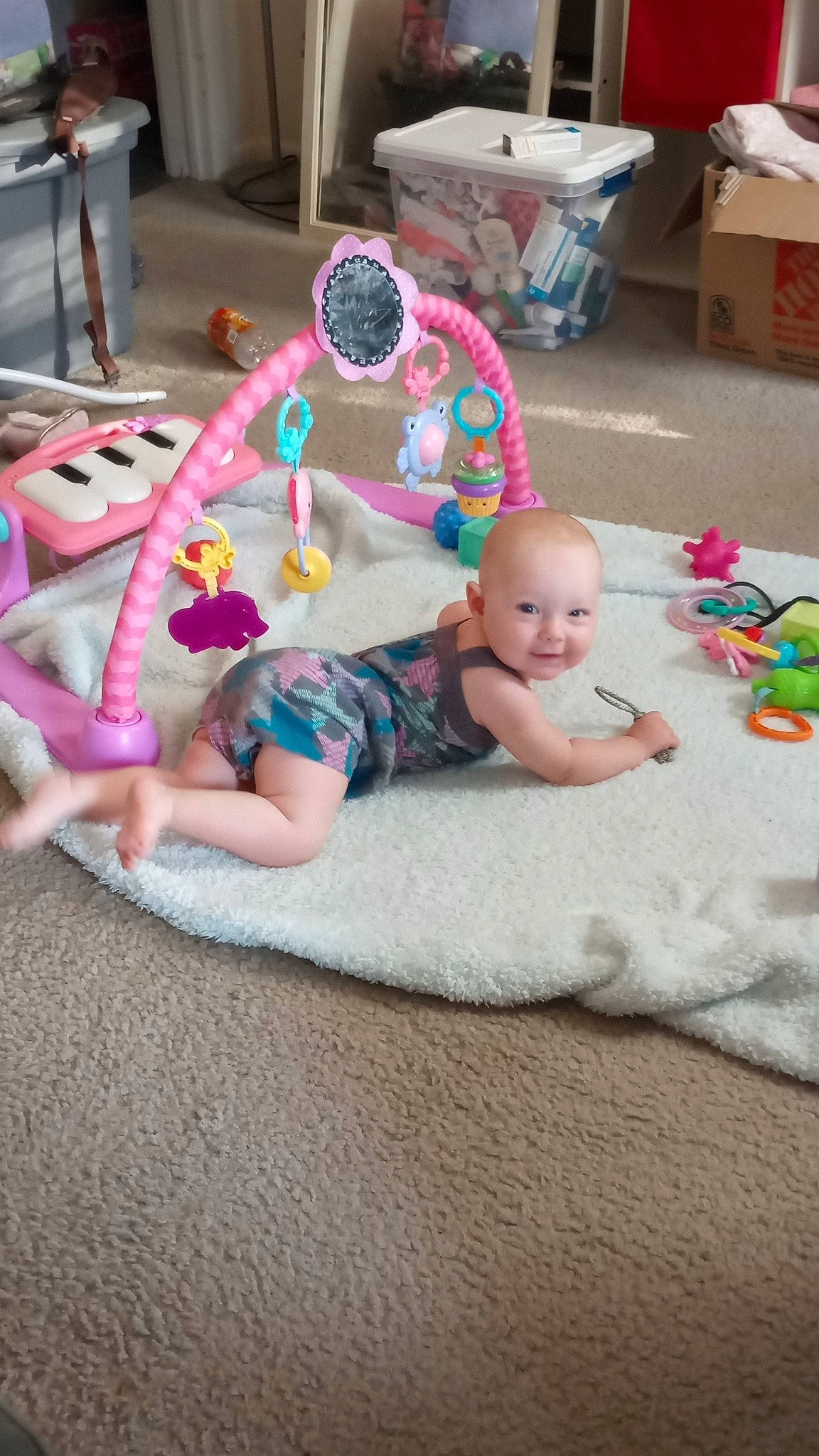 Adaline joined the competition — help win amazing prizes! baby, baby_toddler_clothing, child, comfort, face, flooring, foot, fun, joy, lap, leisure, linens, person, pink, play, room, shipping_box, sitting, smile, sock