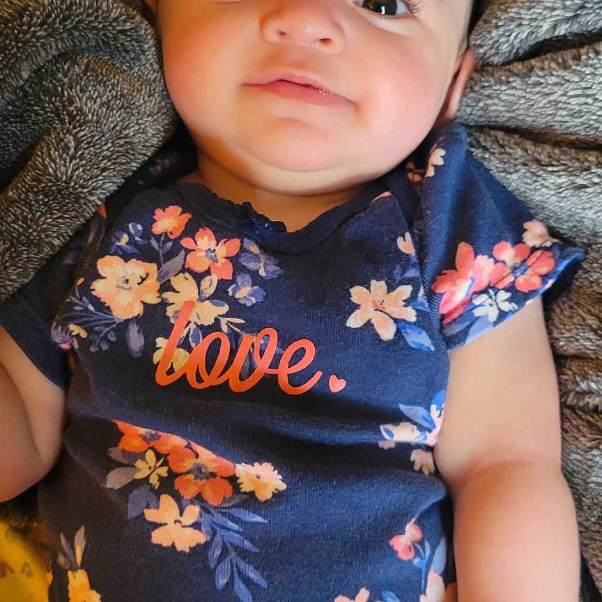 Delilah is registered to the contest to win money with this photo: baby, blanket, bodypart, clothing, cushion, face, finger, furniture, hand, happy, head, homedecor, newborn, pants, person, photography, portrait, sleeping, smile, t_shirt