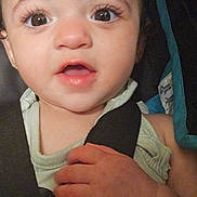 Delilah is registered to the contest to win money with this photo: baby, close_up, face, hand, car_seat, child, infant, expression, wide_eyes, eyelashes, skin, clothing, straps, seatbelt, cute, portrait, young_child, indoor, human, person