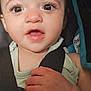 baby, close_up, face, hand, car_seat, child, infant, expression, wide_eyes, eyelashes, skin, clothing, straps, seatbelt, cute, portrait, young_child, indoor, human, person