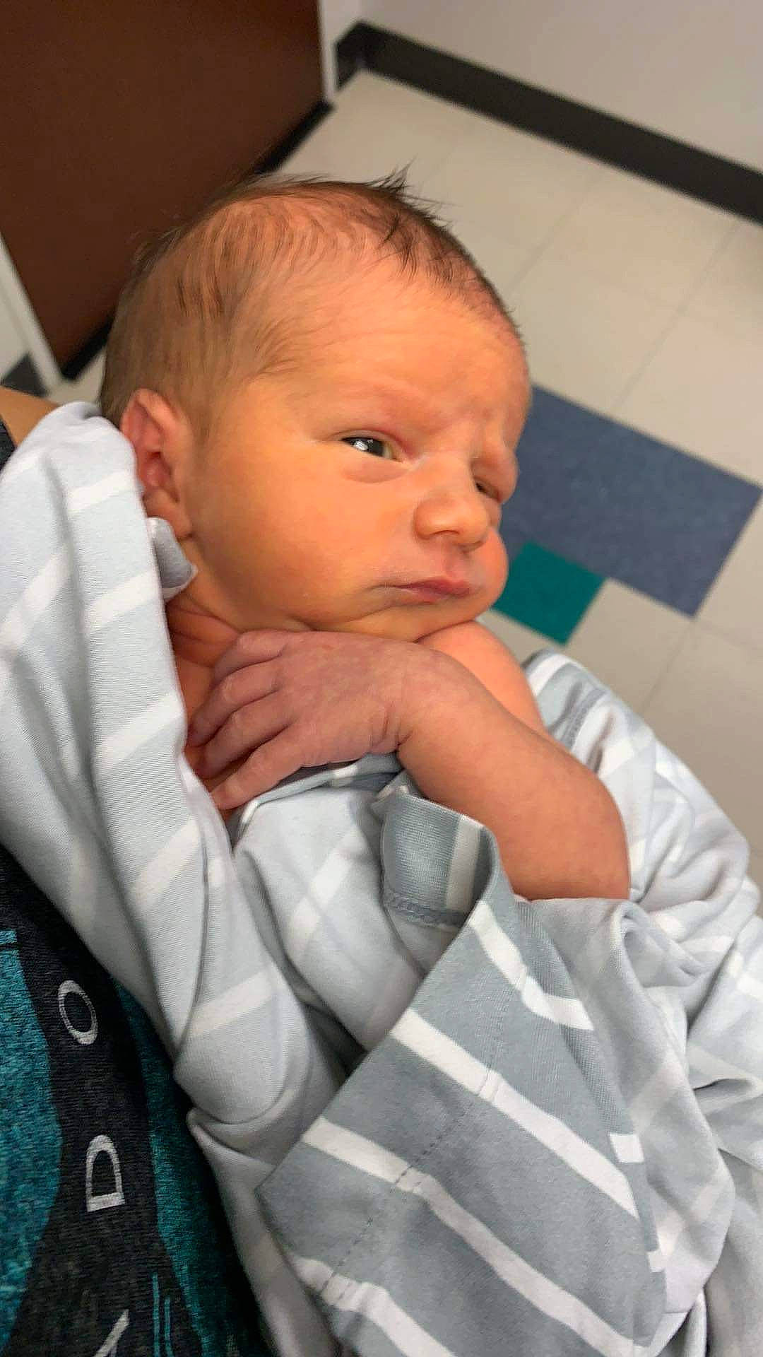 Oliver is registered to the contest to win money with this photo: baby, baby_toddler_clothing, cheek, child, chin, comfort, ear, eyebrow, finger, fun, gesture, iris, lip, mouth, nose, person, sitting, skin, sleeve, thumb