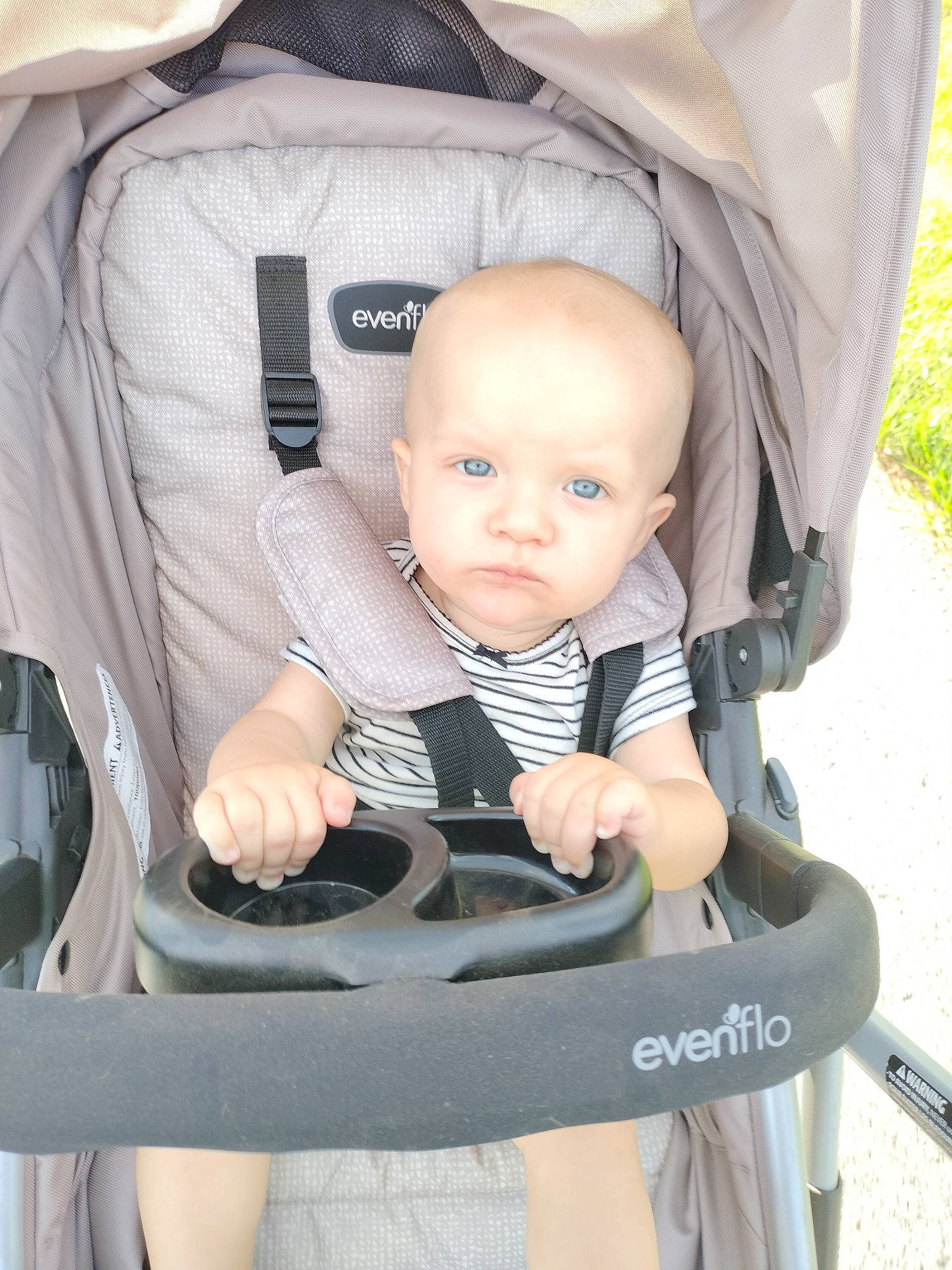 Eden is registered to the contest to win money with this photo: auto_part, baby, baby_carriage, baby_products, baby_safety, baby_toddler_clothing, chair, child, comfort, grass, lap, person, sitting, toddler