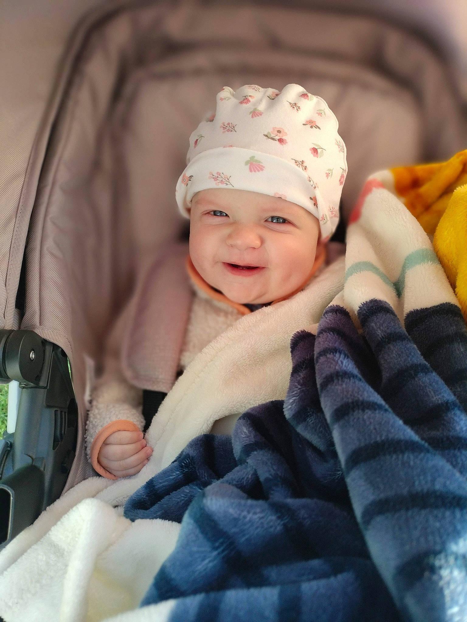Eden is registered to the contest to win money with this photo: baby, baby_products, baby_sleeping, baby_toddler_clothing, cap, car_seat, child, comfort, face, facial_expression, fashion_accessory, happy, headwear, knit_cap, linens, person, seat_belt, sitting, skin, smile