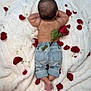 baby, infant, denim_jeans, rose, rose_petals, blanket, soft_texture, flower, skin, back_view, cute, small_feet, rolled_jeans, relaxing, lying_down, nature_elements, decorative, adorable, peaceful, young_child