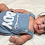 baby, infant, smile, romper, clothing, blue, blanket, soft, cute, child, skin, happy, lying_down, face, cheeks, button, small_hand, indoors, portrait, newborn