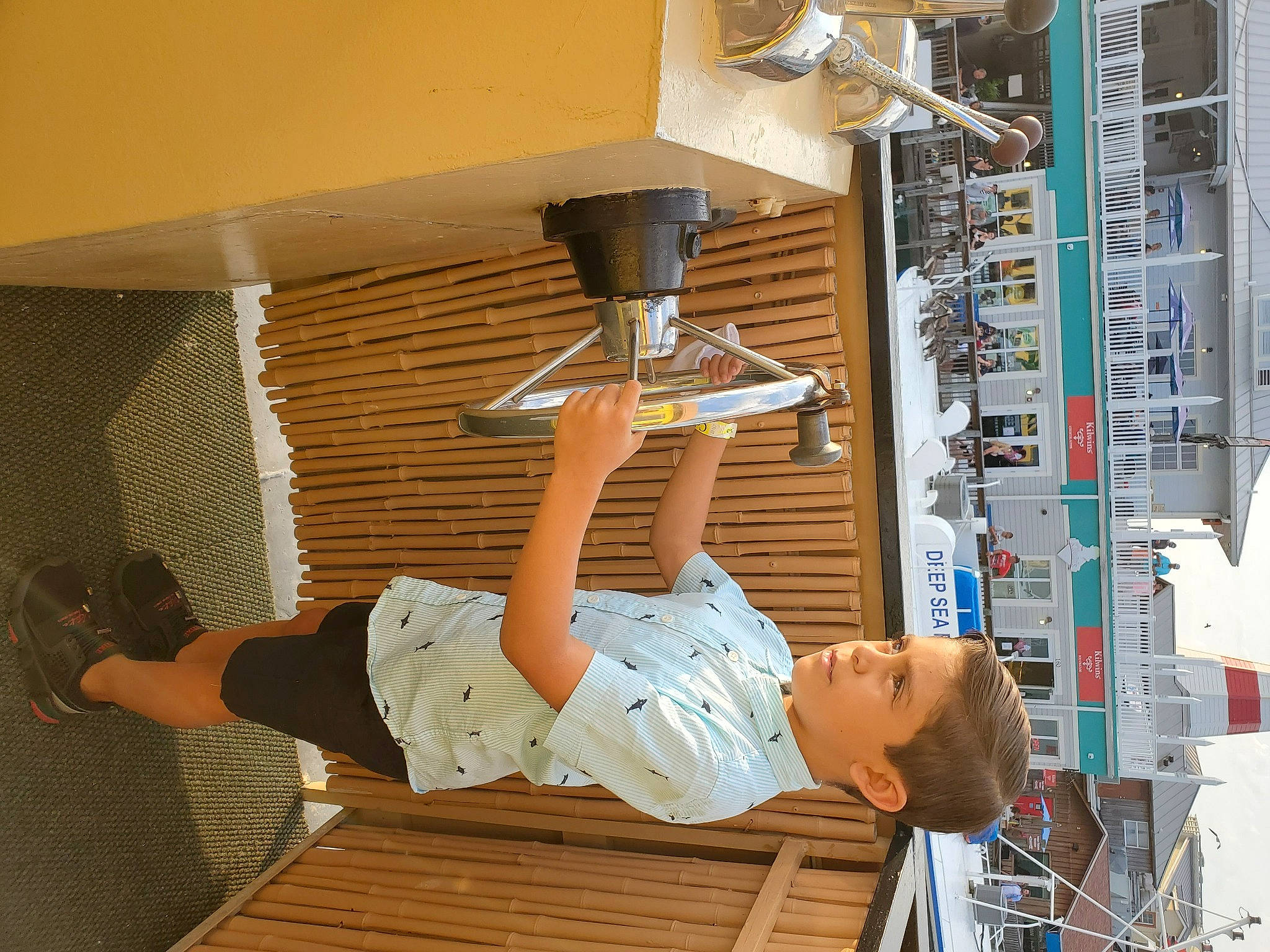 Ethan is registered to the contest to win money with this photo: building, ceiling, elbow, engineering, facade, flooring, hardwood, hat, human_leg, knee, light_fixture, machine, person, room, shorts, t_shirt, thigh, wood