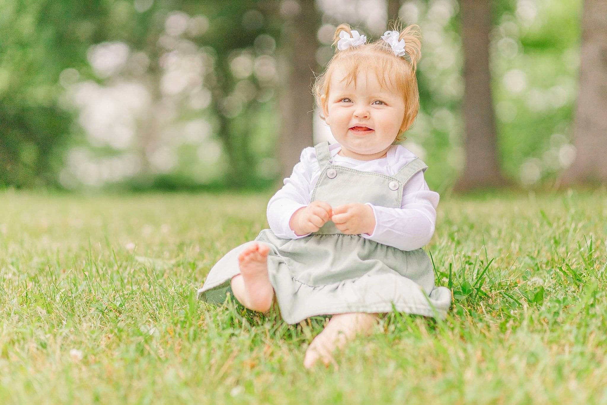 Liberty Lewis is registered to the contest to win money with this photo: baby, baby_toddler_clothing, child, dress, flash_photography, fun, grass, grassland, happy, head, headband, headpiece, joy, people_in_nature, person, plant, portrait_photography, sitting, skin, smile