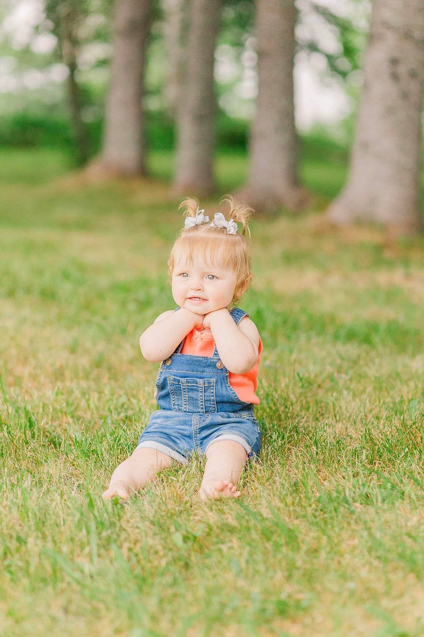 Liberty Lewis is registered to the contest to win money with this photo: baby, baby_toddler_clothing, child, eye, face, grass, grassland, happy, head, leaf, mammal, meadow, people_in_nature, person, plant, smile, summer, sunlight, toddler, tree