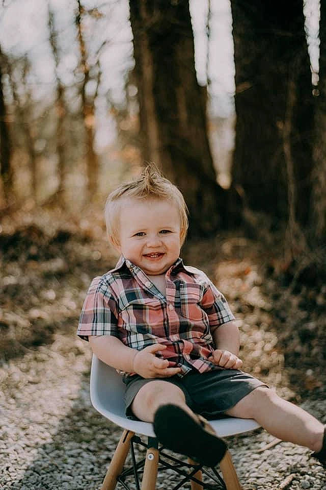 Hunter joined the competition — help win amazing prizes! flash_photography, forest, grass, happy, joy, leaf, leisure, pattern, people_in_nature, person, plaid, plant, shoe, shorts, sitting, smile, sneakers, t_shirt, tartan, toddler