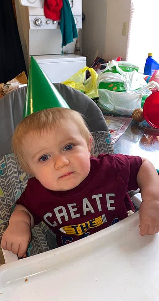 Hunter is registered to the contest to win money with this photo: baby, baby_toddler_clothing, birthday, chair, cheek, child, desk, fun, green, logo, party, party_supply, person, play, room, sitting, t_shirt, table, toddler, vacation