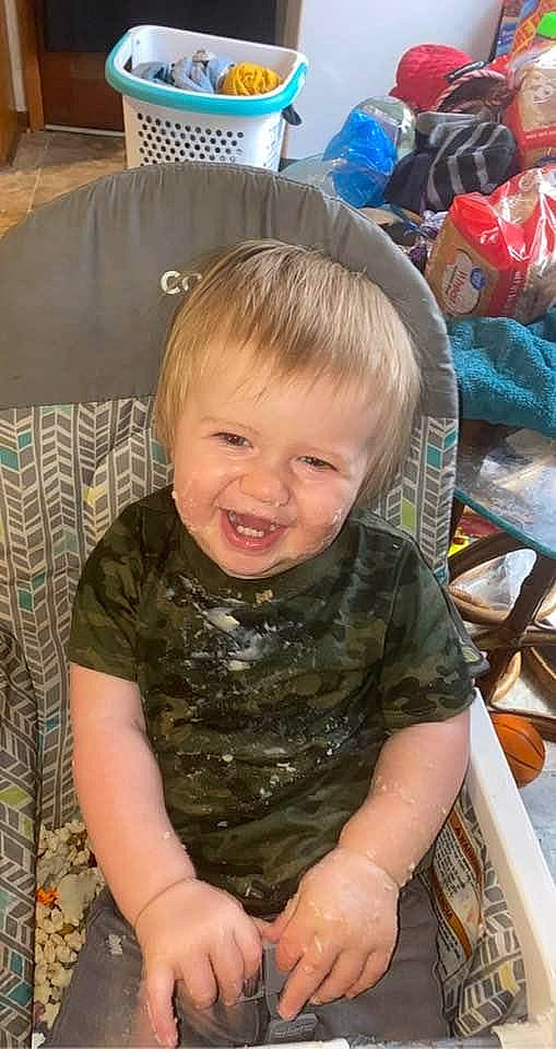 Hunter is registered to the contest to win money with this photo: baby, baby_toddler_clothing, chair, cheek, child, comfort, couch, eye, flooring, fun, happy, head, lap, pattern, person, room, sitting, sleeve, smile, textile