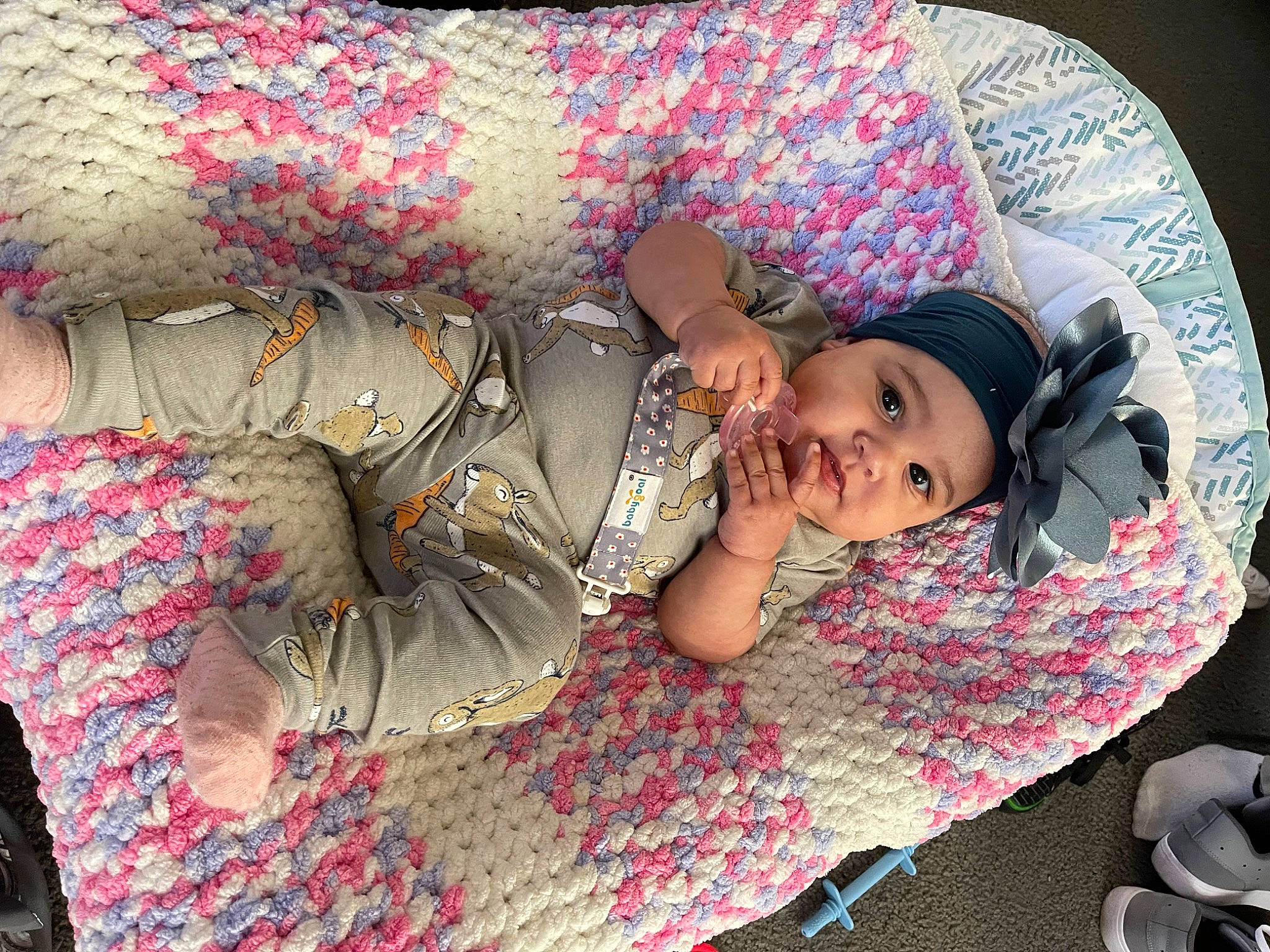 Makayla is registered to the contest to win money with this photo: baby, beauty, child, comfort, dress, fashion_accessory, flooring, fun, grass, hat, headwear, human_body, leisure, linens, magenta, pattern, person, pink, sitting, textile