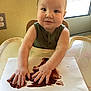 Charlie joined the competition — help win amazing prizes! toddler, child, baby, high_chair, finger_painting, paper, messy, painting, smile, face, arms, hands, indoor, window, yellow_wall, clothing, green_shirt, table, light, expression