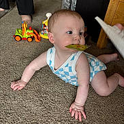 Charlie is registered to the contest to win money with this photo: baby, crawling, carpet, indoor, child, toy, card, hand, foot, furniture, person, blue_clothing, curious, floor, home, infant, play, carpeted_floor, indoors, young_child