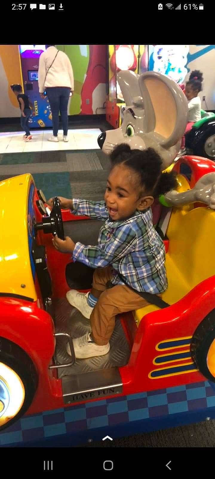 Nehemiah is registered to the contest to win money with this photo: automotive_design, automotive_exterior, automotive_tire, automotive_wheel_system, bumper, fun, leisure, mode_of_transport, motor_vehicle, person, photograph, public_space, recreation, riding_toy, smile, standing, tire, toddler, vehicle, wheel