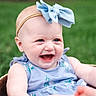 Alyssa is registered to the contest to win money with this photo: baby, child, smiling, blue_bow, headband, dress, outdoor, grass, basket, happy, infant, portrait, cute, nature, skin, person, summer, sitting, young, cheerful