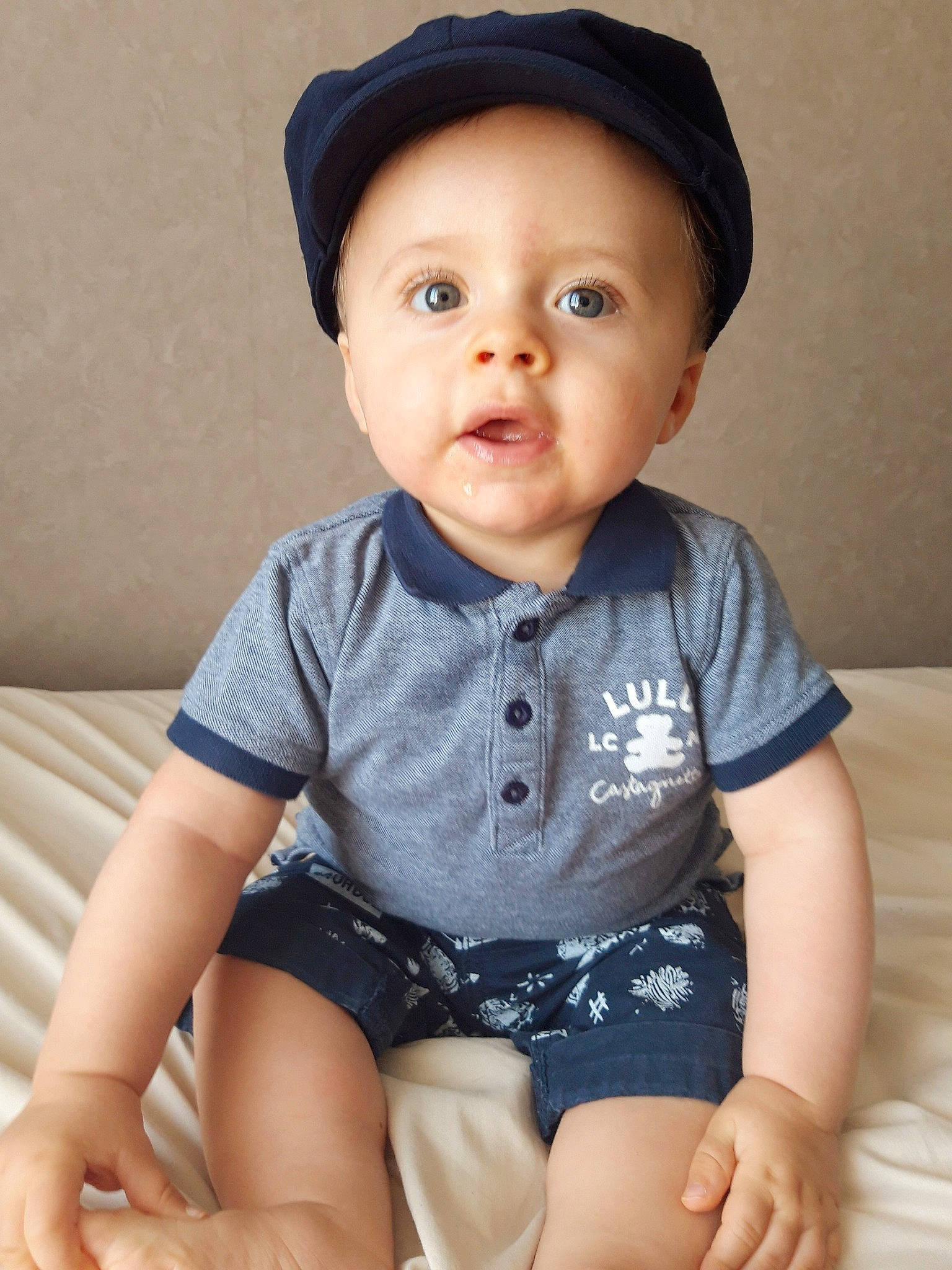 Tomy participe au concours pour gagner de l'argent avec cette photo : baby, baby_products, baby_toddler_clothing, cheek, child, child_model, headgear, headwear, person, sitting, skin, sleeve, t_shirt, toddler