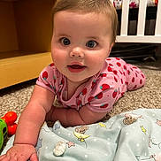 Everly is registered to the contest to win money with this photo: baby, child, crawling, pink_clothing, strawberry_pattern, carpet, toy, nursery, crib, blanket, toddler, cute, indoor, infant, playtime, hand, face, smiling, happy, home