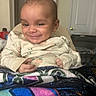 Jezimae is registered to the contest to win money with this photo: baby, blanket, casual, child, clothing, cozy, cute, expression, face, furniture, happy, home, indoor, infant, person, portrait, sitting, smiling, soft_lighting, young_child