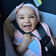 Jezimae joined the competition — help win amazing prizes! baby, baby_girl, car_interior, car_seat, child, child_seat, closeup, cute, face, happy, headband, indoor, infant, person, pink_clothing, portrait, safety, seatbelt, smiling, toddler