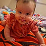 Oaklynn joined the competition — help win amazing prizes! baby, infant, child, cute, smiling, tongue_out, orange_blanket, bedroom, pillow, colorful, indoor, playful, clothing, face, portrait, young_child, happy, lying_down, soft_lighting, cozy