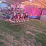 children, carnival, amusement_ride, grass, outdoor, daylight, play, fun, smiling, friends, summer, entertainment, leisure, activity, festival, happy, people, youth, casual_clothing, recreation