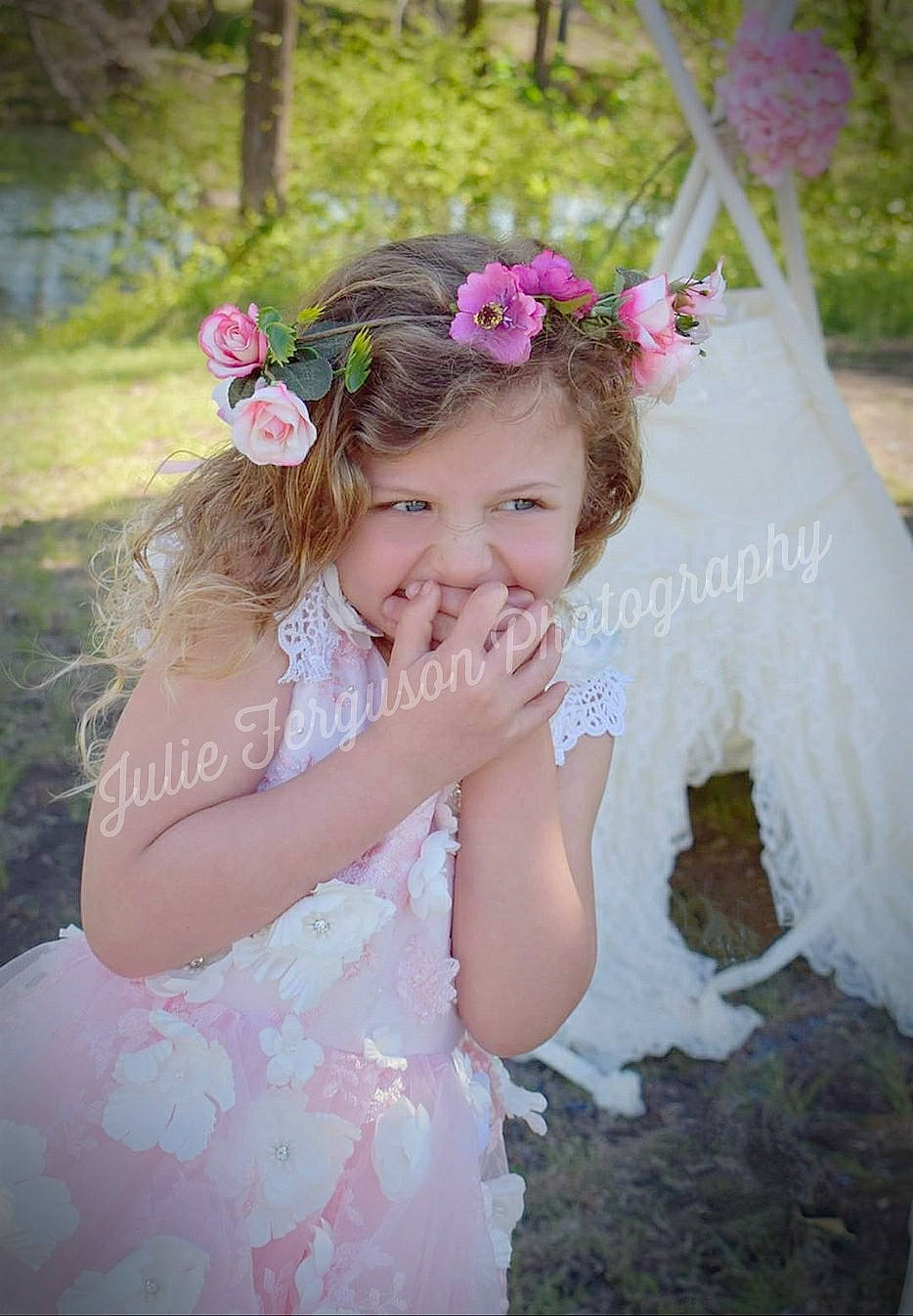 Fallon is registered to the contest to win money with this photo: baby, bridal_accessory, ceremony, child, child_model, clothing, costume, dress, fashion_accessory, flower, hair_accessory, headband, headgear, headpiece, joy, person, petal, pink, plant, toddler