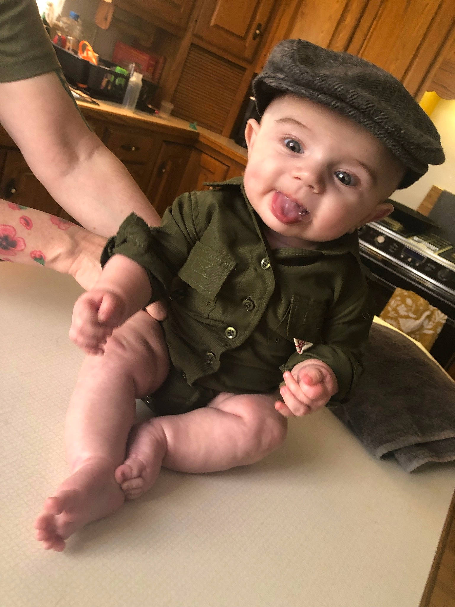 Killian is registered to the contest to win money with this photo: arm, baby, cheek, child, eye, finger, gesture, hand, head, human_body, leg, person, sitting, skin, thumb, toddler