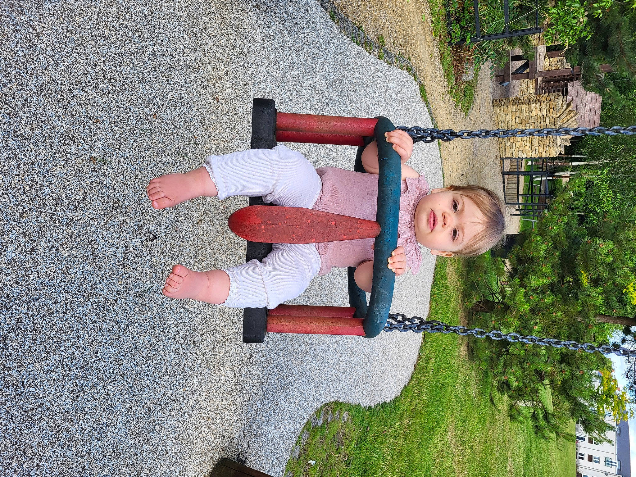 Esme is registered to the contest to win money with this photo: asphalt, carmine, child, concrete, fun, grass, human_leg, landscape, leisure, people_in_nature, person, plant, recreation, road_surface, sidewalk, smile, tar, thigh, toddler, tree