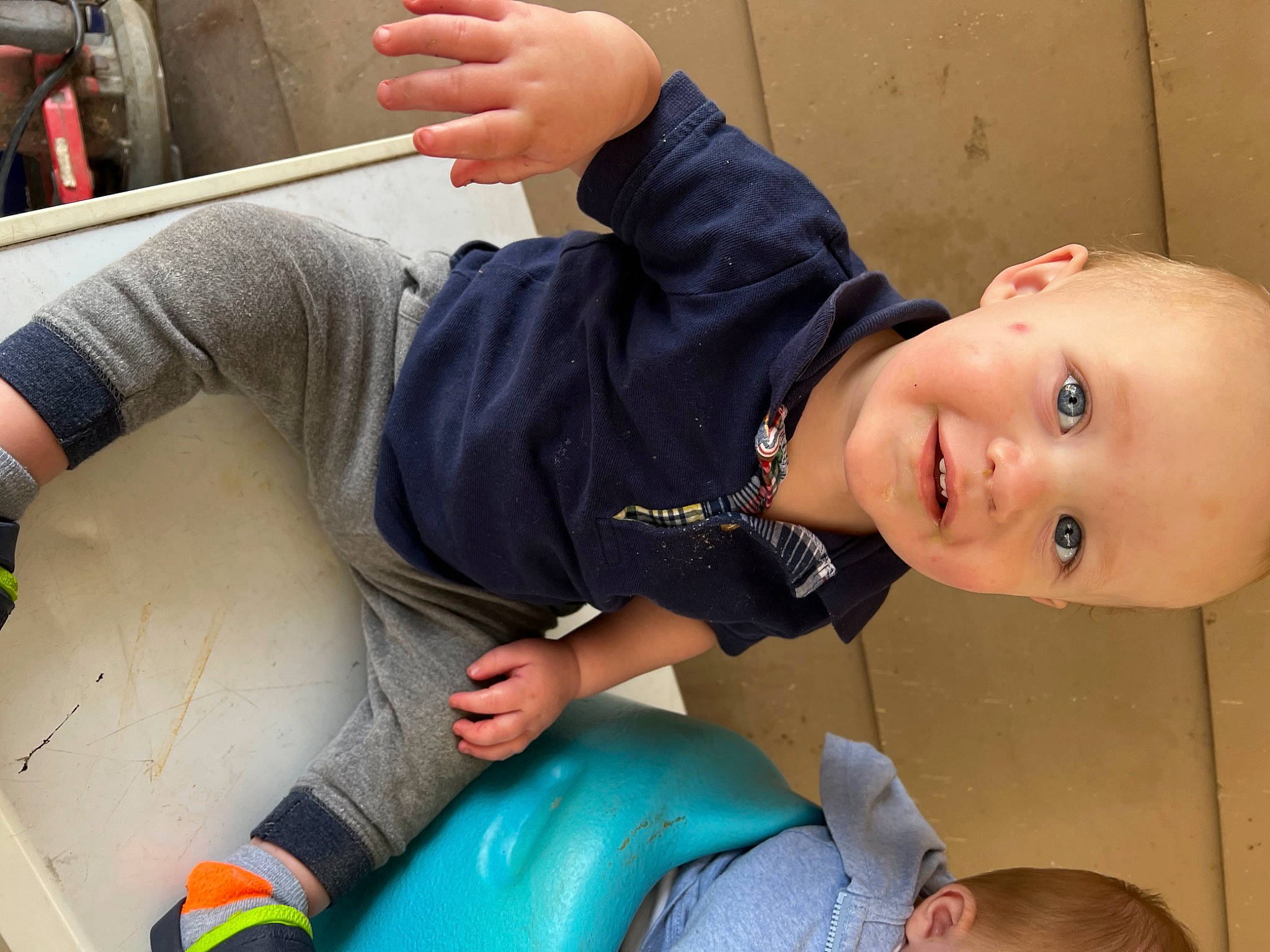 Weston is registered to the contest to win money with this photo: child, cool, elbow, finger, fun, gesture, grass, happy, human_leg, joint, knee, leg, leisure, mouth, person, sitting, skin, smile, thigh, thumb