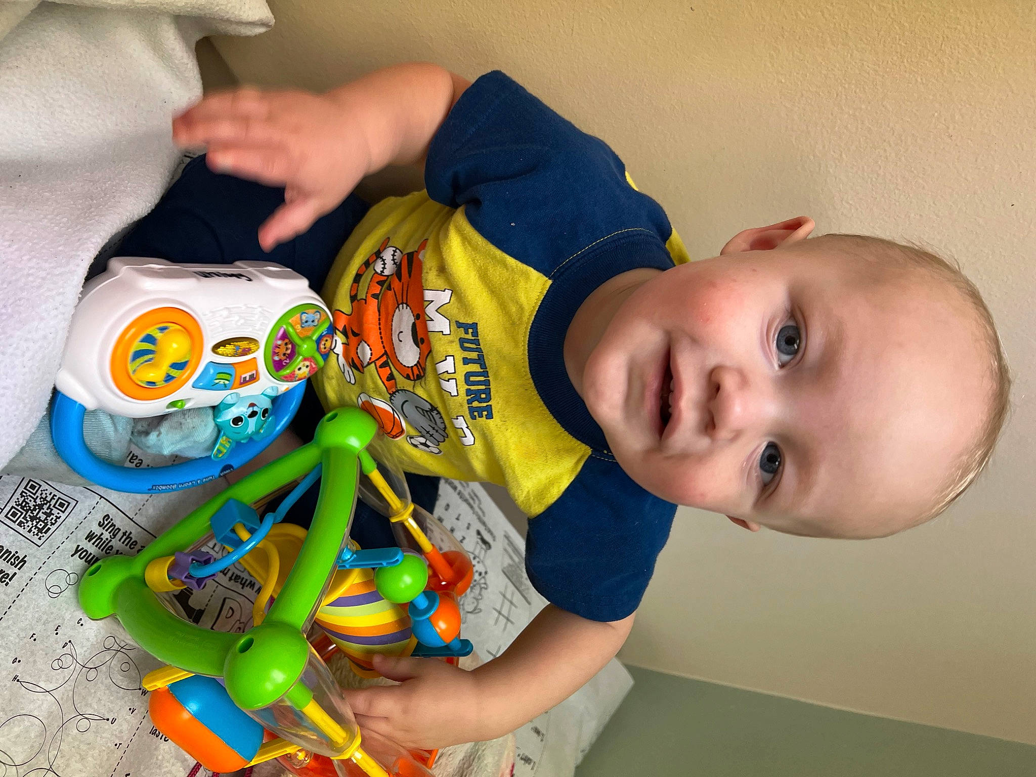 Weston is registered to the contest to win money with this photo: baby, baby_products, baby_toddler_clothing, baby_toys, child, finger, fun, hand, happy, junk_food, mouth, nail, person, plastic, play, room, sleeve, smile, t_shirt, toddler